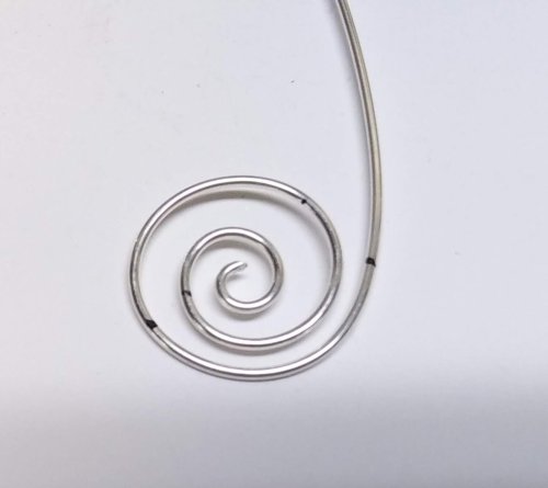 Judy Larson's Bali Style Earrings - , Contemporary Wire Jewelry, Stamping, Stamps, Butane Torch, Soldering, Solder, Drilling, Drill, Scroll a 4” (101.5mm) section of 18 gauge wire into a circle